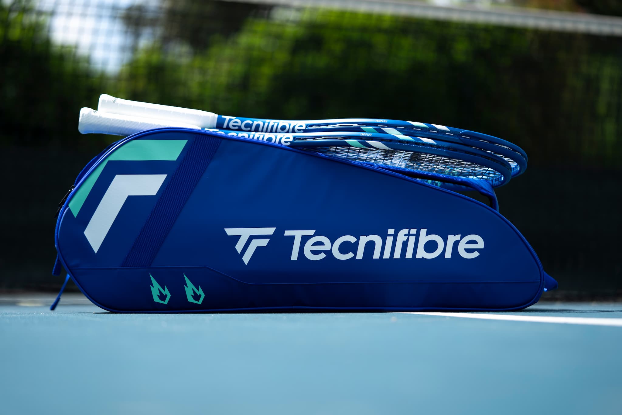 Tecnifibre tennis racket and bag on a tennis court