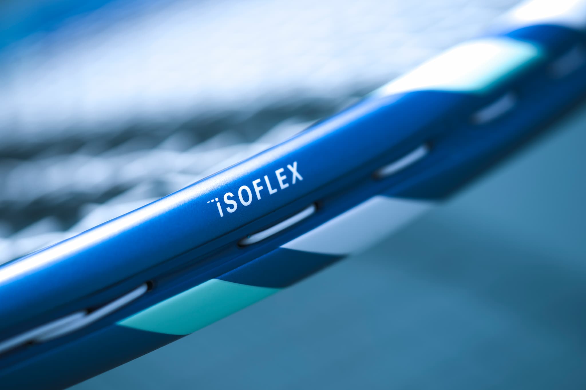 Close-up of a blue iSOFLEX  racquet product with a blurred background