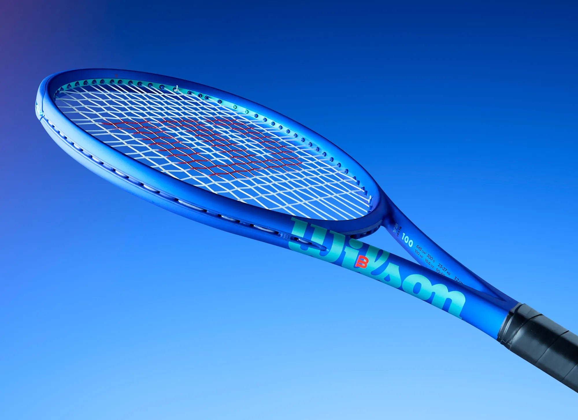 Blue Wilson tennis racket against a blue background