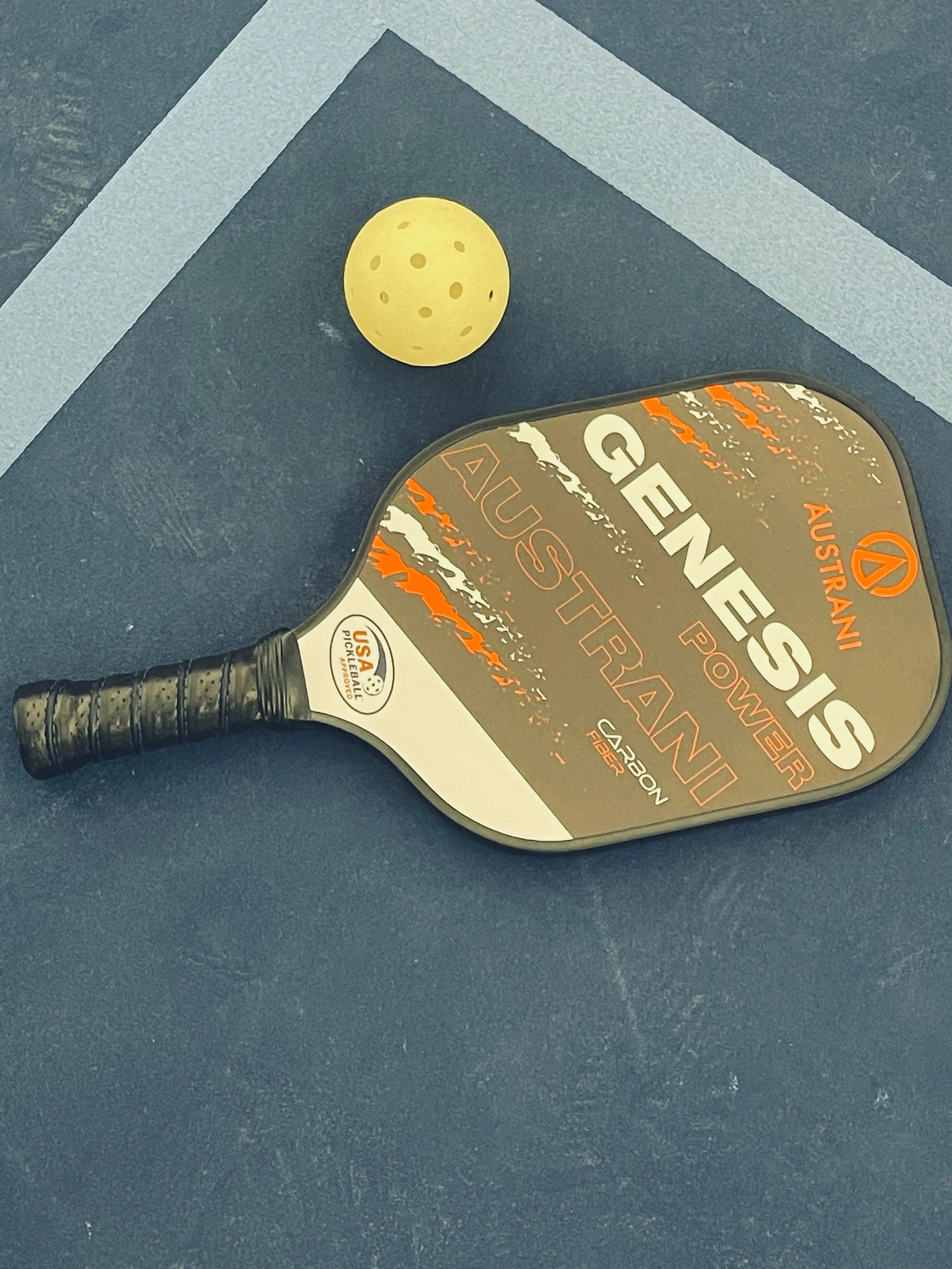 Austrani Genesis Power Pickleball Paddle and a pickleball on the court