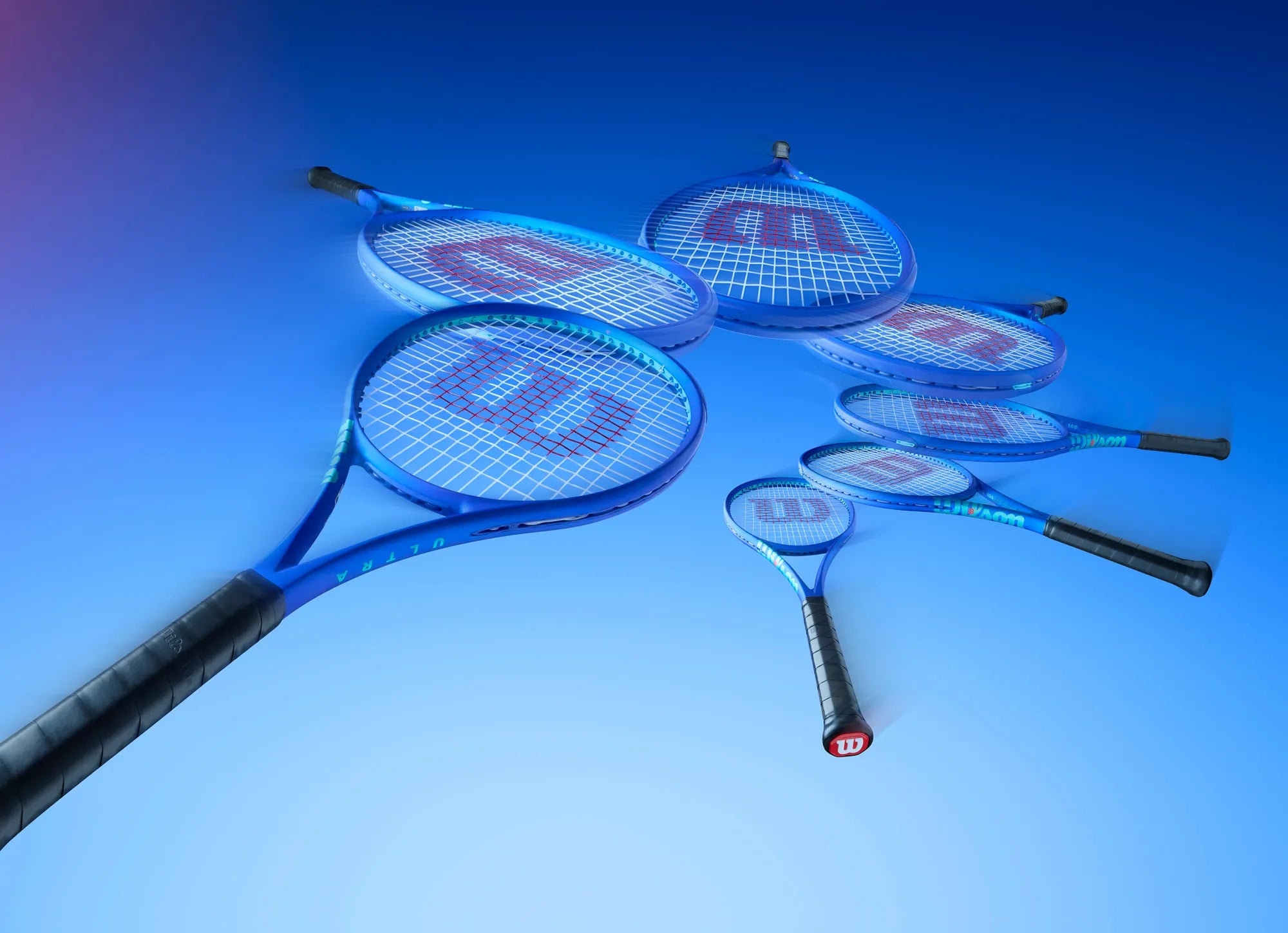 Multiple tennis rackets with Wilson branding on a blue gradient background