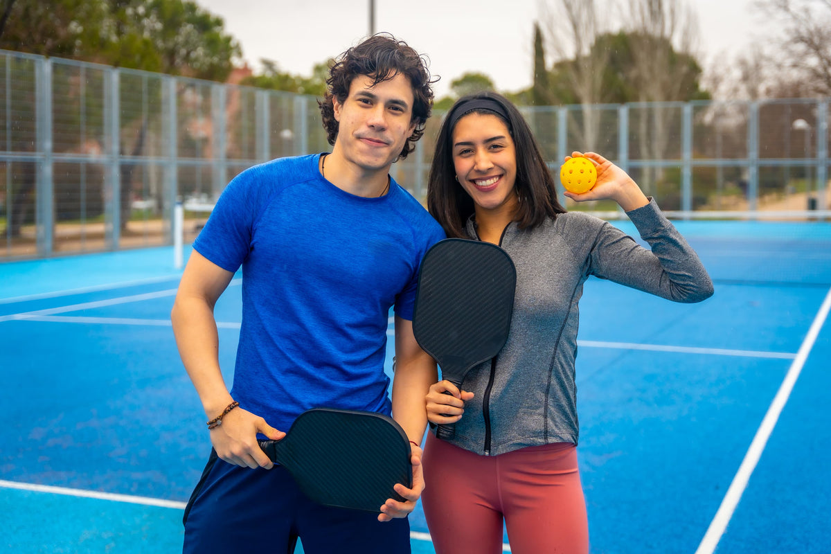 Pickleball gear including paddles, shoes and accessories on court