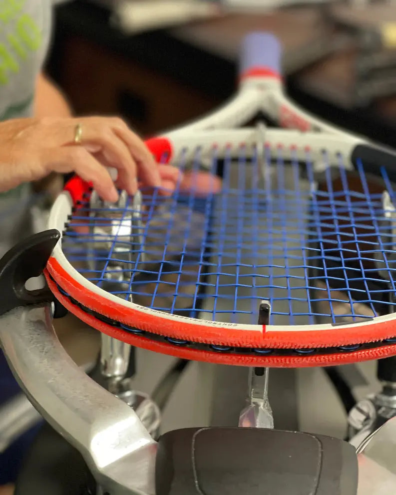 Close-up image of a tennis racquet being strung